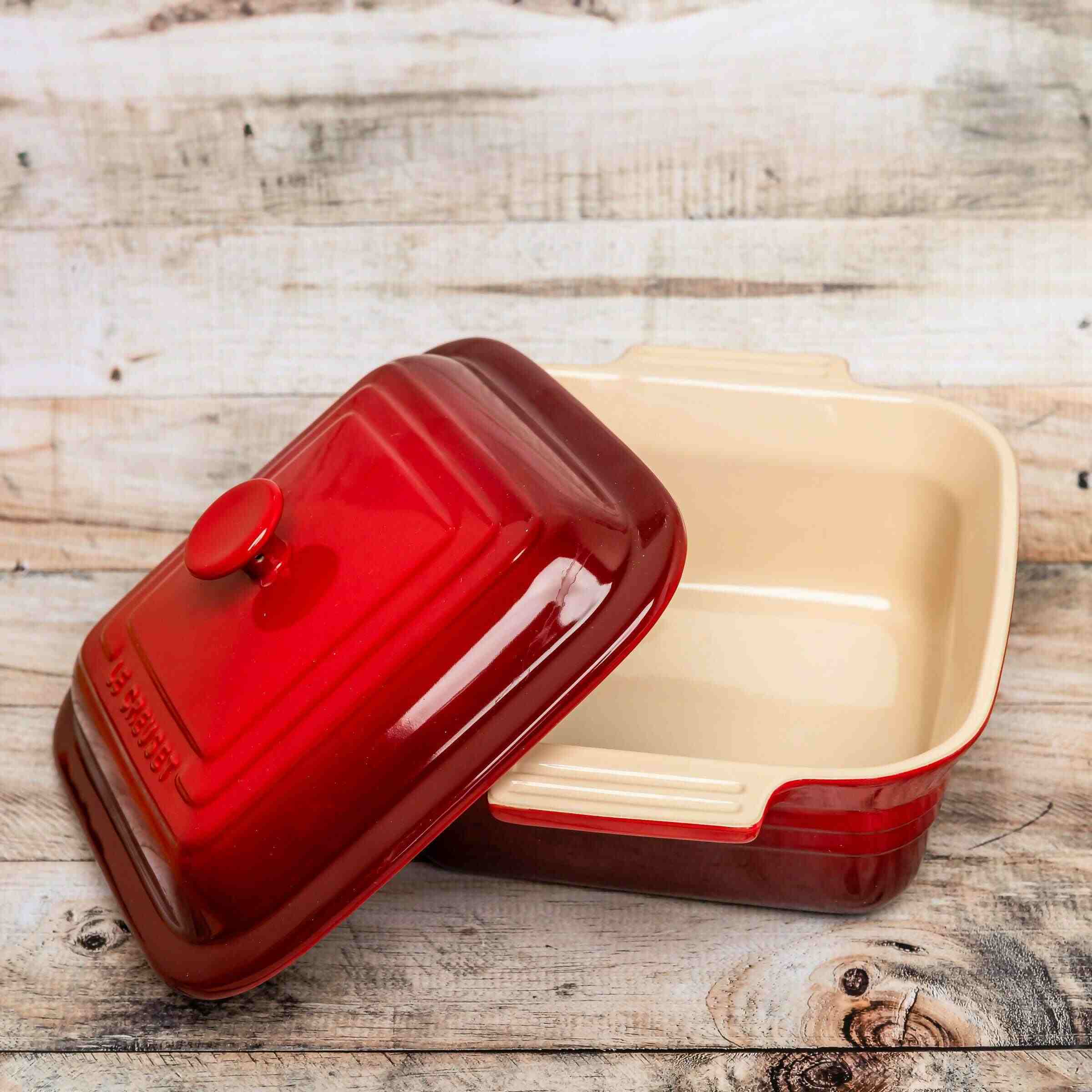 Pre-owned, gently used cerise Le Creuset Stoneware 3 Quart Square Casserole Dish With Lid, lid off to side